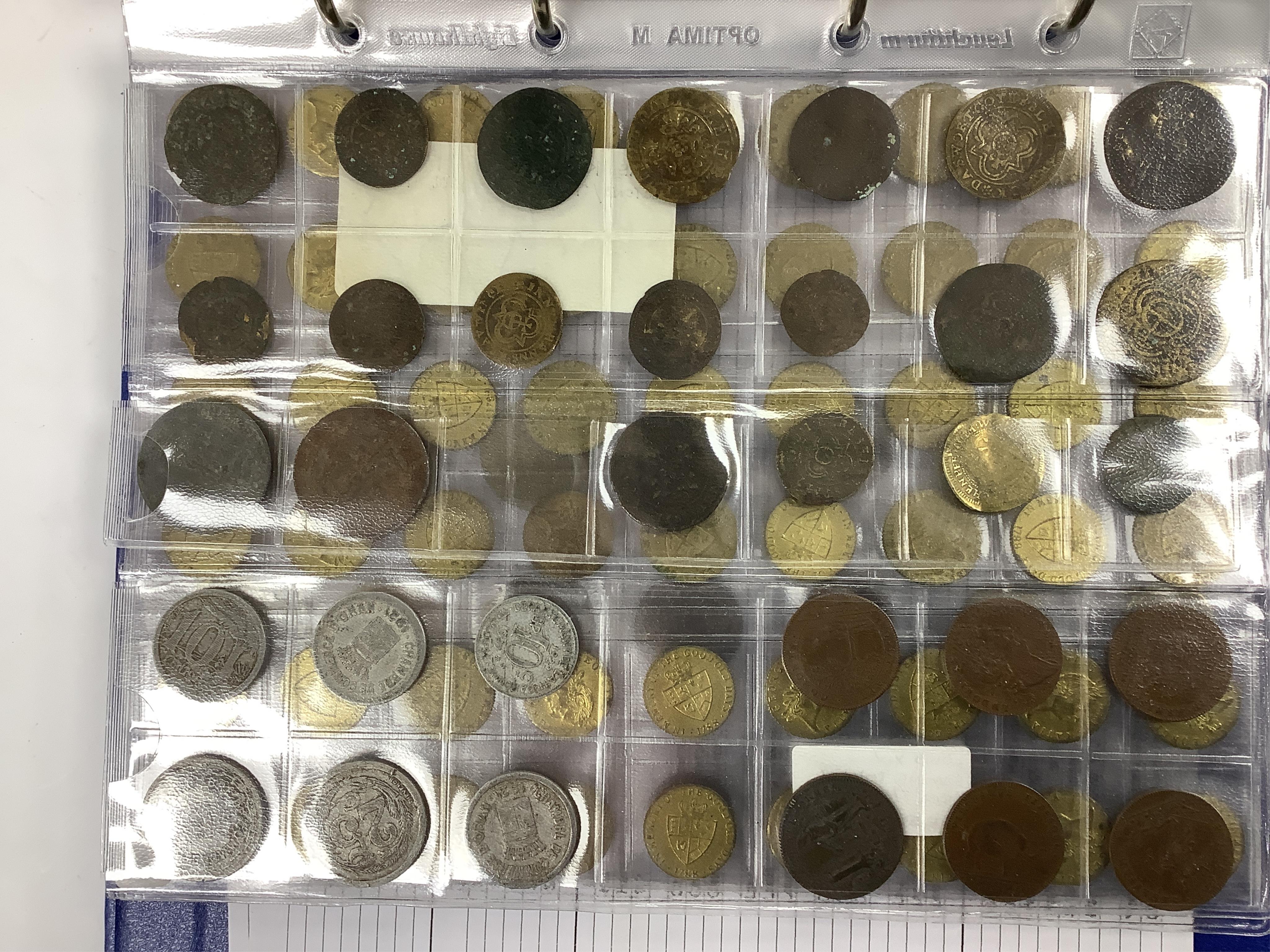 A large collection of halfpenny tokens and gaming tokens, 17th to early 20th century, in an album